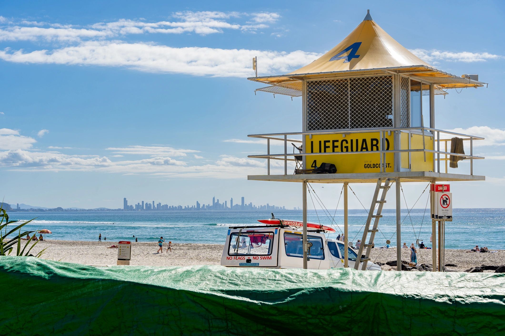 A lifeguard station on the beach at Coolangatta, with the skyline of Surfers Paradise in the background